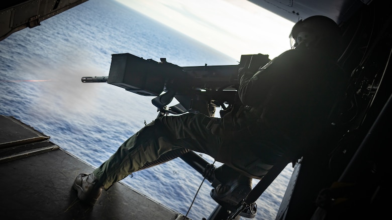 U.S. Marine Corps Sgt. Conor Terry, Tiltrotor Crew Chief with 1st Marine Aircraft Wing, fires an M240D 7.62mm machine gun after a deck landing qualification training on the Expeditionary Sea Base (ESB) 6 USS John L. Canley as part of exercise Warrior Voyage in Hawaii, Oct. 10, 2024. Exercise Warrior Voyage is a group-level training event that evaluates the ESB as an afloat platform for intermediate-level aviation logistics and hot refueling options in support of the Aviation Combat Element.