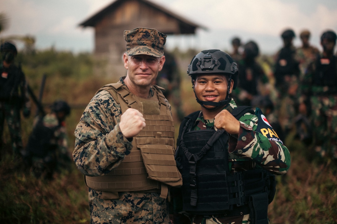 U.S. Marine Corps Col. Stuart Glenn, left, commanding officer for Marine Rotational Force-Southeast Asia, poses for a photo with an Indonesian marine with 10th Marine Infantry Battalion, Indonesian Korps Marinir, after a coastal defense exercise during Keris Marine Exercise (MAREX) 2024 on Kabupaten Lingga, Singkep, Indonesia, Nov. 15, 2024. Keris MAREX is a bilateral exercise conducted by the U.S. Marine Corps and Korps Marinir Republik Indonesia, or Indonesian Marine Corps, to strengthen relationships as military partners and increase interoperability among participating forces in the advancement of a Free and Open Indo-Pacific. MRF-SEA is a rotational unit derived from elements of I Marine Expeditionary Force executing a U.S. Marine Corps Forces, Pacific operational model that involves training events and exchanges with partner military subject matter experts, promotes security goals with Allied and partner nations, and ensures a persistent I MEF presence west of the International Date Line. (U.S. Marine Corps photo by Sgt. Shaina Jupiter)