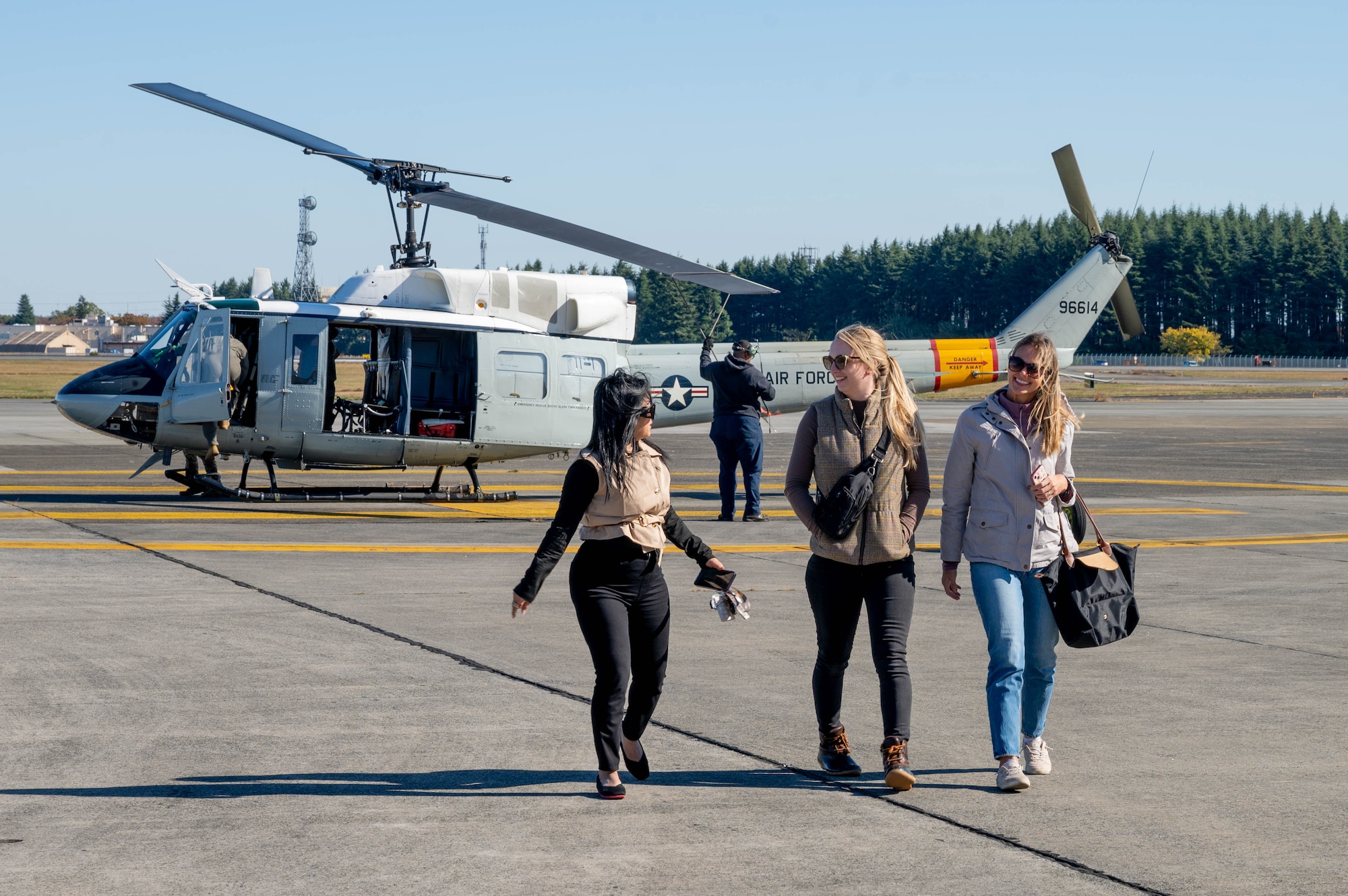 People walk off of helicopter.