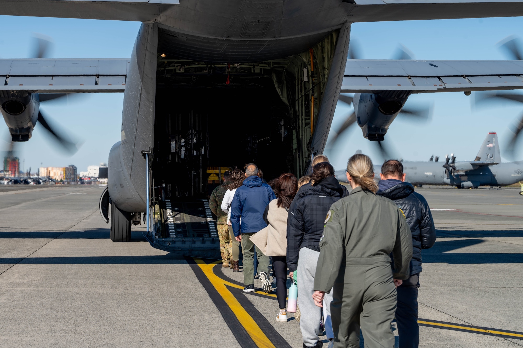 People walk onto a plane.