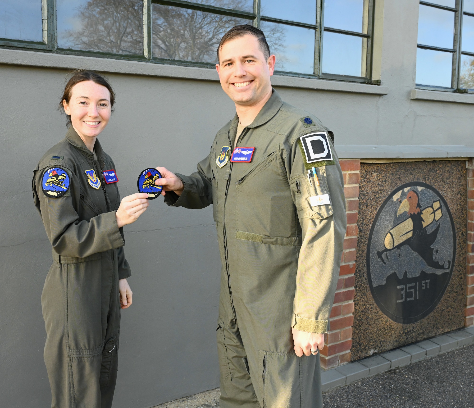 U.S. Air Force Lt. Col. Ryan Chamberlin, right, 351st Air Refueling Squadron director of operations, presents the squadron heritage “Buzzard” patch to 1st Lt. Auburn Suttles, 351st ARS pilot, during a patching ceremony at the 100th Bomb Group Memorial Museum, Thorpe Abbotts, Norfolk, England, Nov. 15, 2024. Pilots and boom operators received their heritage patch once they completed mission-certification training. The Buzzard patch is the heritage patch of the 351st Bomb Squadron and only those who have fully completed MCT can wear the patch. (U.S. Air Force photo by Karen Abeyasekere)