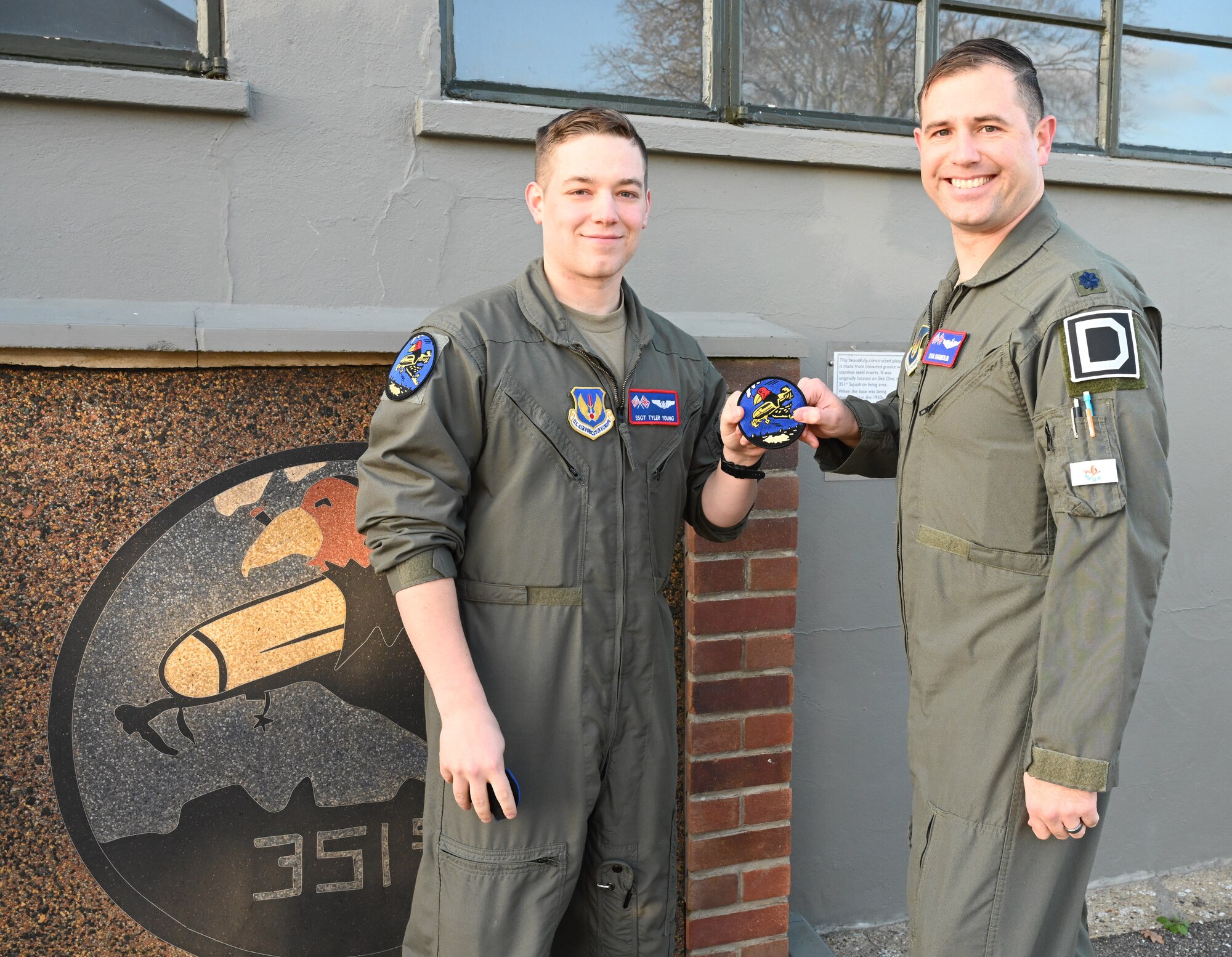 U.S. Air Force Lt. Col. Ryan Chamberlin, right, 351st Air Refueling Squadron director of operations, presents the squadron heritage “Buzzard” patch to Staff Sgt. Tyler Young, 351st ARS boom operator, during a patching ceremony at the 100th Bomb Group Memorial Museum, Thorpe Abbotts, Norfolk, England, Nov. 15, 2024. Pilots and boom operators received their heritage patch once they completed mission-certification training. The Buzzard patch is the heritage patch of the 351st Bomb Squadron and only those who have fully completed MCT can wear the patch. (U.S. Air Force photo by Karen Abeyasekere)