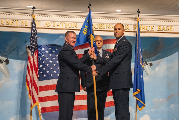 Col. Michael Lynch, 461st Operations Group commander, receives the 461st OSS guidon from Lt. Col. Richard Holt, 461st Operational Support Squadron commander, during the 461st OSS inactivation ceremony at Robins Air Force Base.