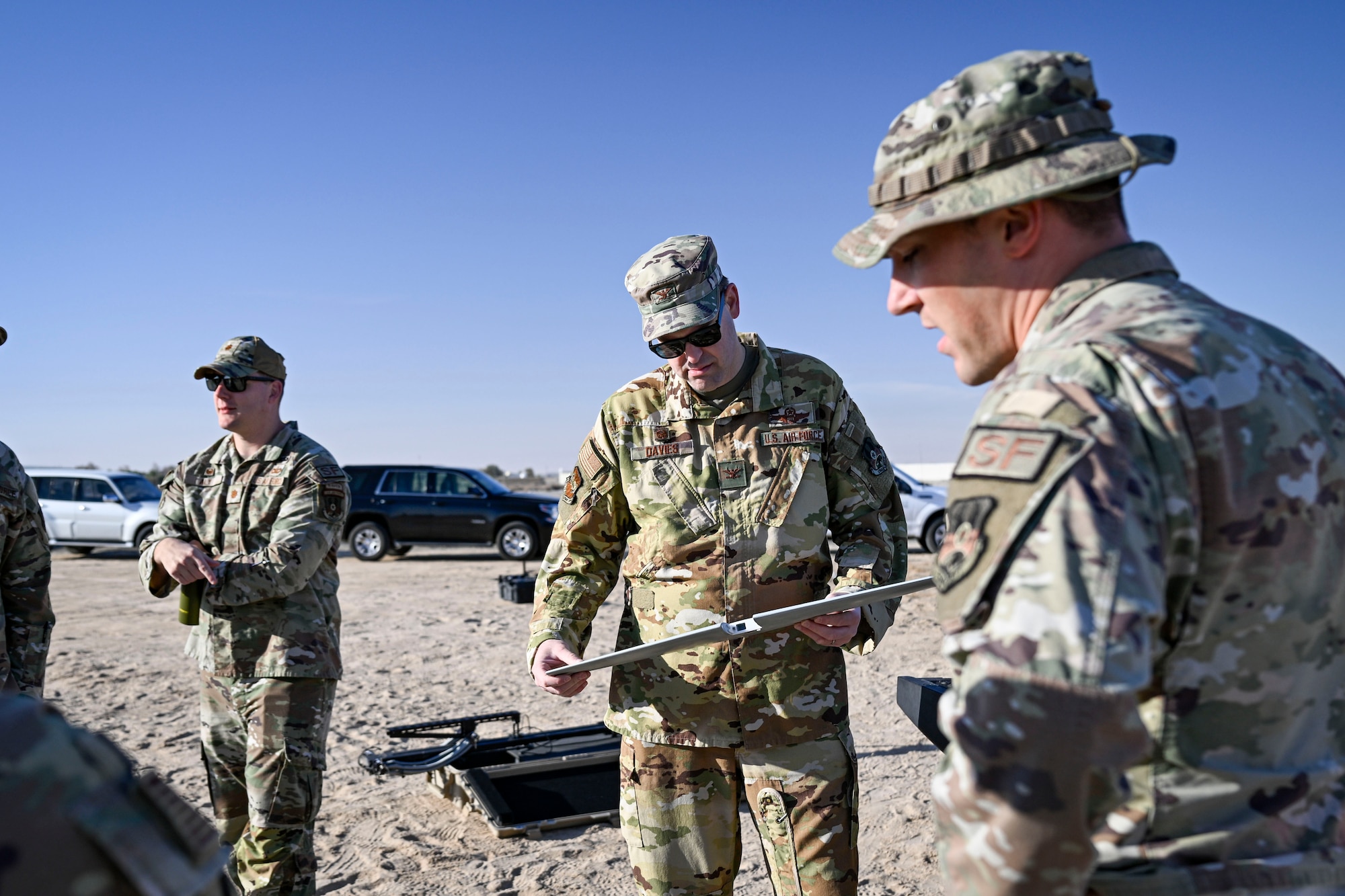 Three Airmen gather outside.