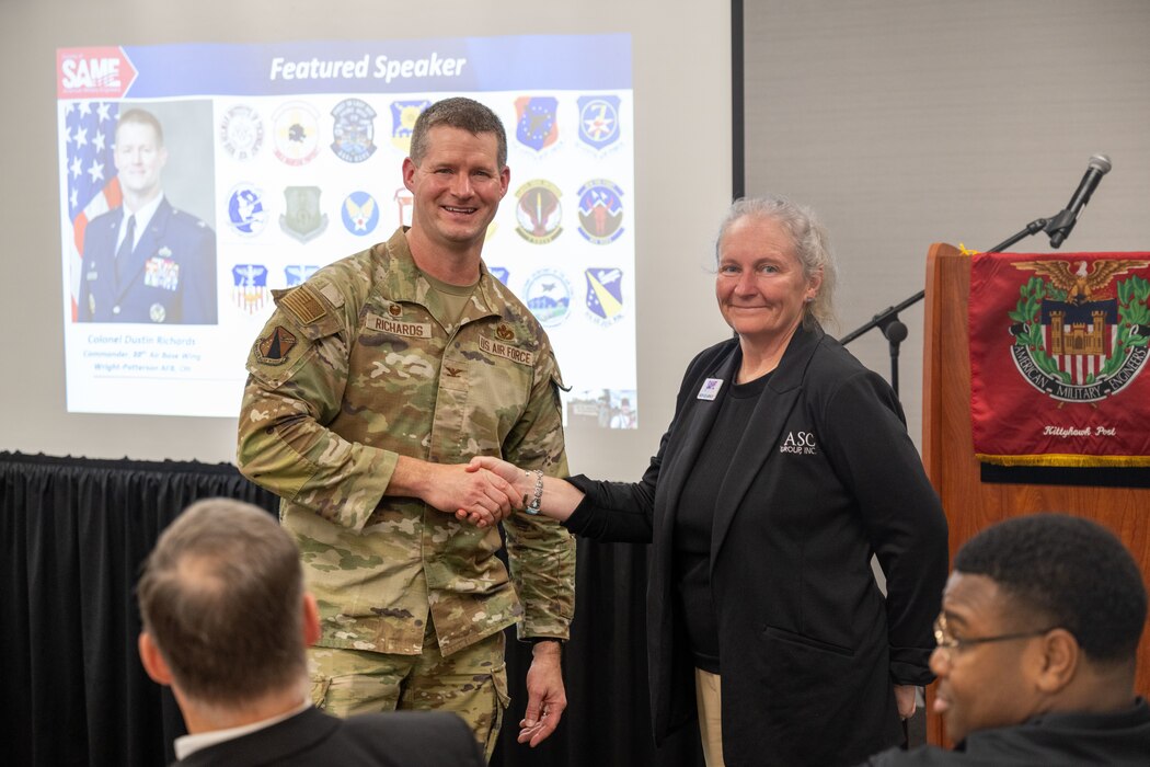 Col. Dustin Richards, 88th Air Base Wing and installation commander, and Nichole Lashley, Kittyhawk Post president, pose for a photo at the Society of American Military Engineers Kittyhawk post.