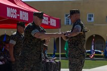 U.S. Marine Corps Col. Jason Freeby, commanding officer of Headquarters and Service Battalion, passes a sword to Sgt. Maj. Thomas Bachman, the new sergeant major of Headquarters and Service Battalion, at a relief and appointment ceremony at Marine Corps Recruit Depot San Diego, California, Oct. 31, 2024. Sgt. Maj. Carlos Aguilera relinquished his position to Bachman, who took charge of the Battalion.  (U.S. Marine Corps photo by Cpl. Alexander O. Devereux)
