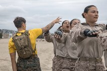 U.S. Marine Corps Staff Sgt. Alyssa Marseilles, a drill instructor with Fox Company, 2nd Recruit Training Battalion, guides a recruit through dynamic warm-ups before their Marine Corps Martial Arts Program class focusing on bayonet techniques at Marine Corps Recruit Depot San Diego, California, Oct. 28, 2024. MCMAP aims to strengthen the mental and moral resiliency of individual recruits and Marines through realistic combative training, warrior ethos studies, and physical hardening. (U.S. Marine Corps photo by Cpl. Sarah M. Grawcock)