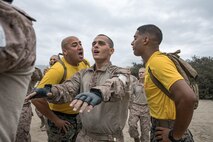 U.S. Marine Corps Staff Sgt. Michael Garcia, left, and Sgt. Justin Miranda, right, both drill instructors with Fox Company, 2nd Recruit Training Battalion, guide recruit Alexander Schmucker through dynamic warm-ups before their Marine Corps Martial Arts Program class focusing on bayonet techniques at Marine Corps Recruit Depot San Diego, California, Oct. 28, 2024. MCMAP aims to strengthen the mental and moral resiliency of individual recruits and Marines through realistic combative training, warrior ethos studies, and physical hardening. (U.S. Marine Corps photo by Cpl. Sarah M. Grawcock)