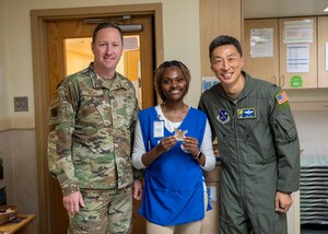 Ms. Shaneka Davis poses after winning an award from Col Oh and Chief Helms