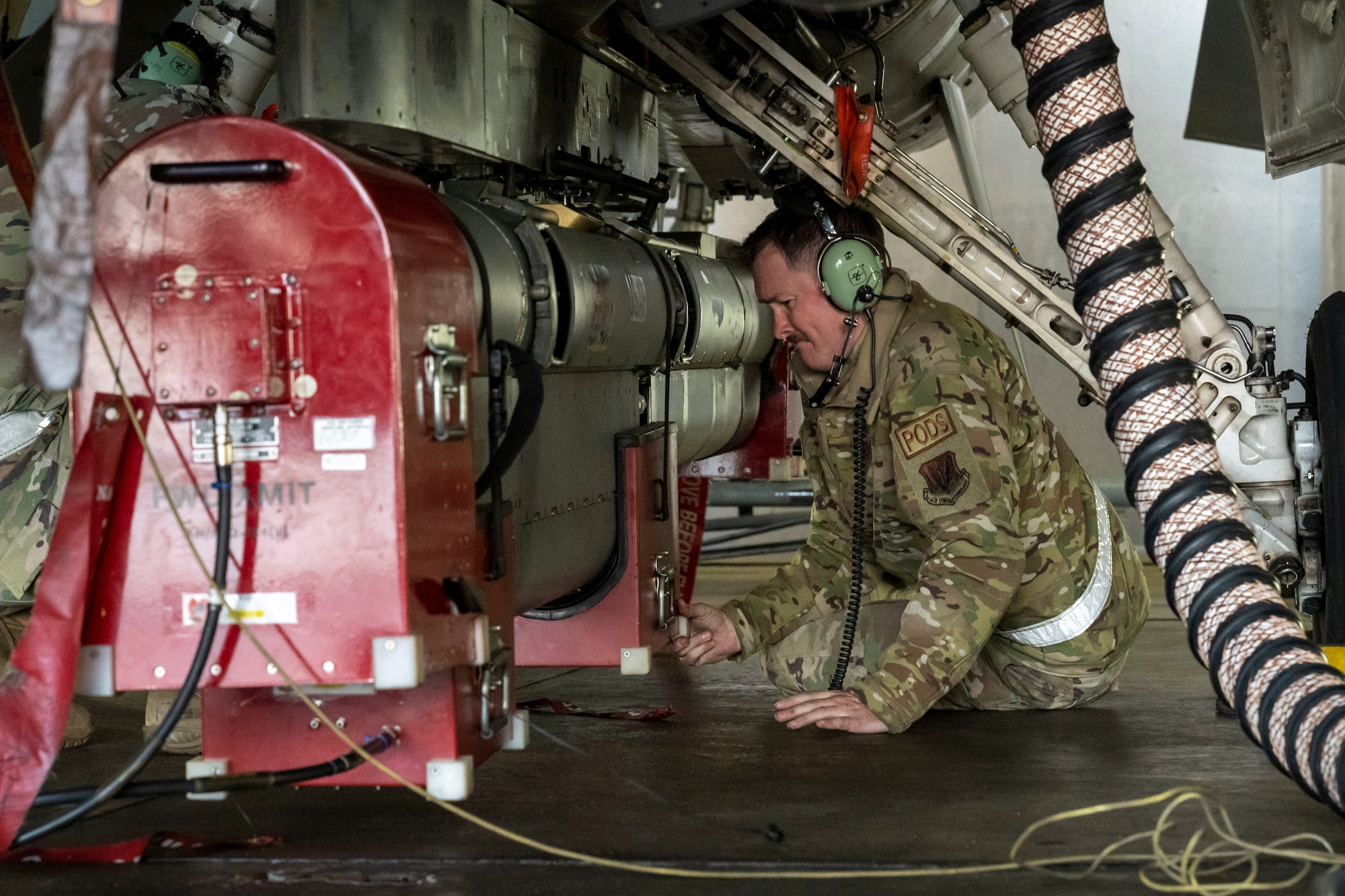 U.S. Air Force Tech. Sgt. Cody Berck, 87th Electronic Warfare Squadron Combat Shield section chief, examines the underside of a U.S. Air Force F-16 Fighting Falcon during a Combat Shield readiness assessment at Misawa Air Base, Japan, Nov. 5, 2024. Combat shield assessments evaluate the effectiveness of the F-16 Fighting Falcon's defensive systems such as radar, jamming, and electronic warfare in realistic combat scenarios, identifying potential vulnerabilities to ensure operational readiness. (U.S. Air Force photo by Airman 1st Class Patrick Boyle)