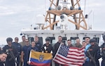 Men standing on boats holding flags.