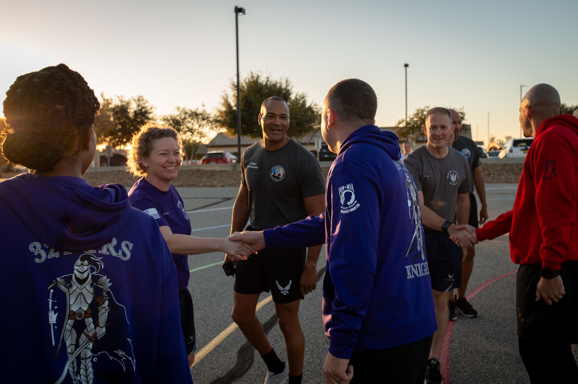 Brig. Gen. Amy Bumgarner, Air Force Office of Special Investigations commander, shakes hands with a Basic Military Training instructor as Col. Billy R. Wilson Jr., 737th Training Group commander, walks alongside them, preparing to join the trainees for the Airman’s Run Nov. 6, 2024, at Joint Base San Antonio-Lackland, Texas. Chief Master Sgt. James Hoy, AFOSI command chief, also exchanges greetings nearby, highlighting leadership engagement in celebrating the trainees final run before graduation. (U.S. Air Force photo by Thomas Brading)