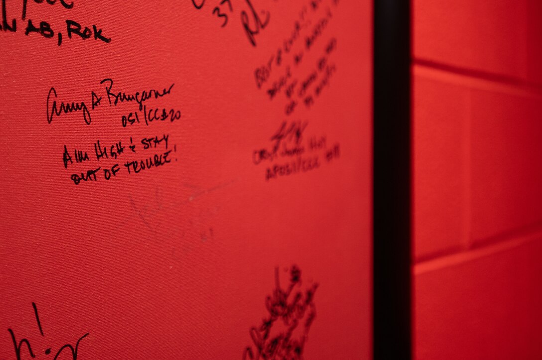 A close-up of Brig. Gen. Amy Bumgarner's message on the 320th Training Squadron's wall at the 320th Training Squadron during her visit to Joint Base San Antonio-Lackland, Texas, Nov. 7, 2024. The Air Force Office of Special Investigations commander left a note alongside her signature: 'Aim high and stay out of trouble.’ (U.S. Air Force photo by Thomas Brading)