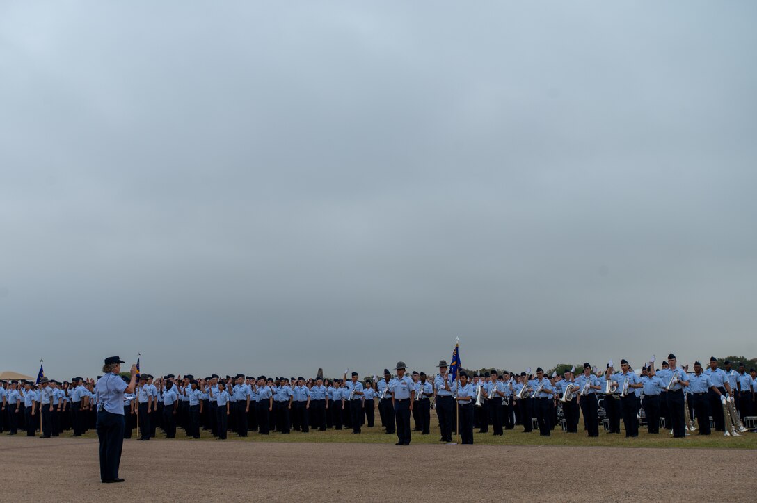 Brig. Gen. Amy Bumgarner, Air Force Office of Special Investigations commander, raises her right hand as she leads the newest Airmen and Guardians through their Oath of Enlistment, Nov. 7, 2024, during a Basic Military Training graduation ceremony at Joint Base San Antonio-Lackland, Texas. (U.S. Air Force photo by Thomas Brading)