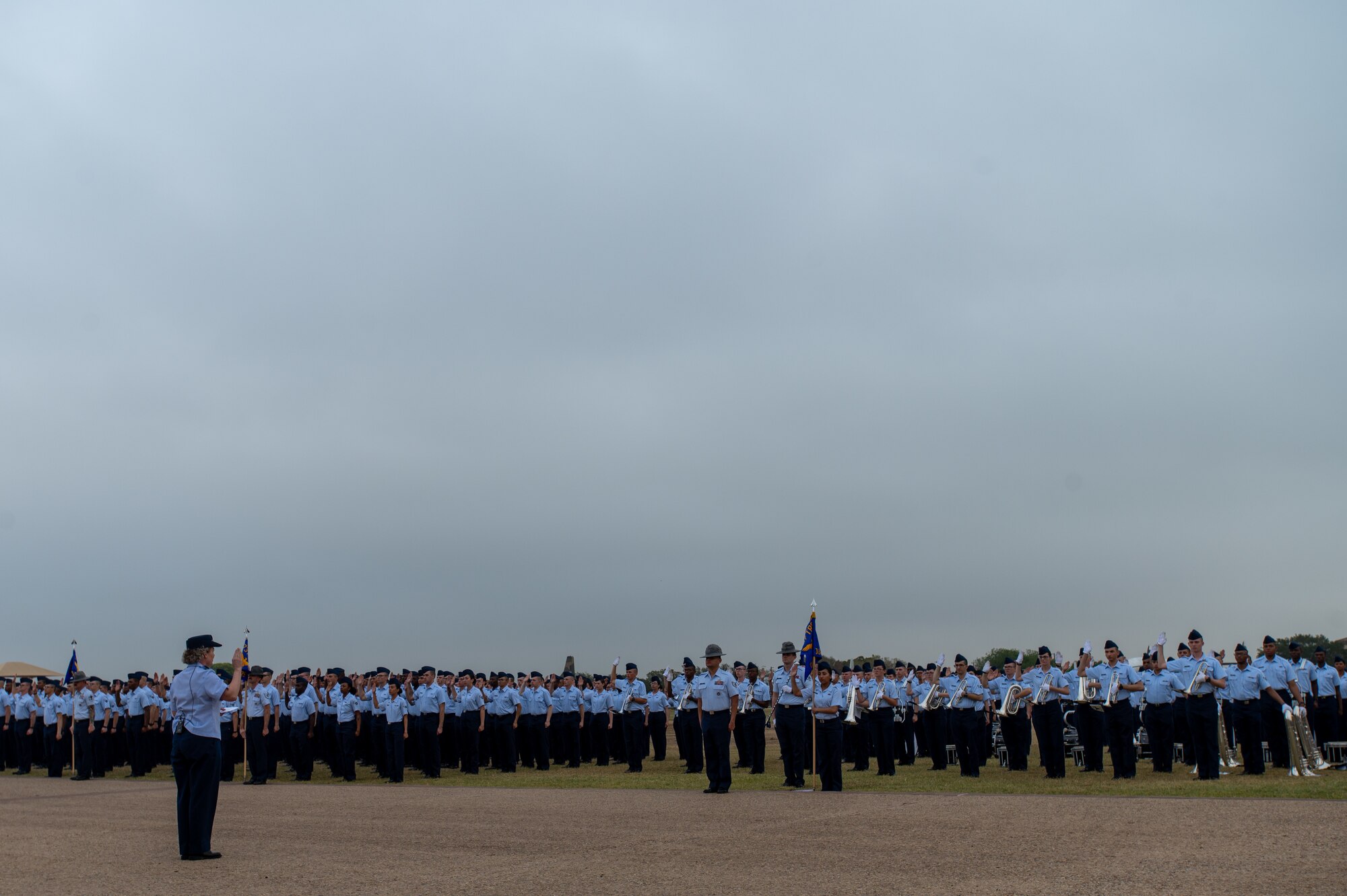 Brig. Gen. Amy Bumgarner, Air Force Office of Special Investigations commander, raises her right hand as she leads the newest Airmen and Guardians through their Oath of Enlistment, Nov. 7, 2024, during a Basic Military Training graduation ceremony at Joint Base San Antonio-Lackland, Texas. (U.S. Air Force photo by Thomas Brading)