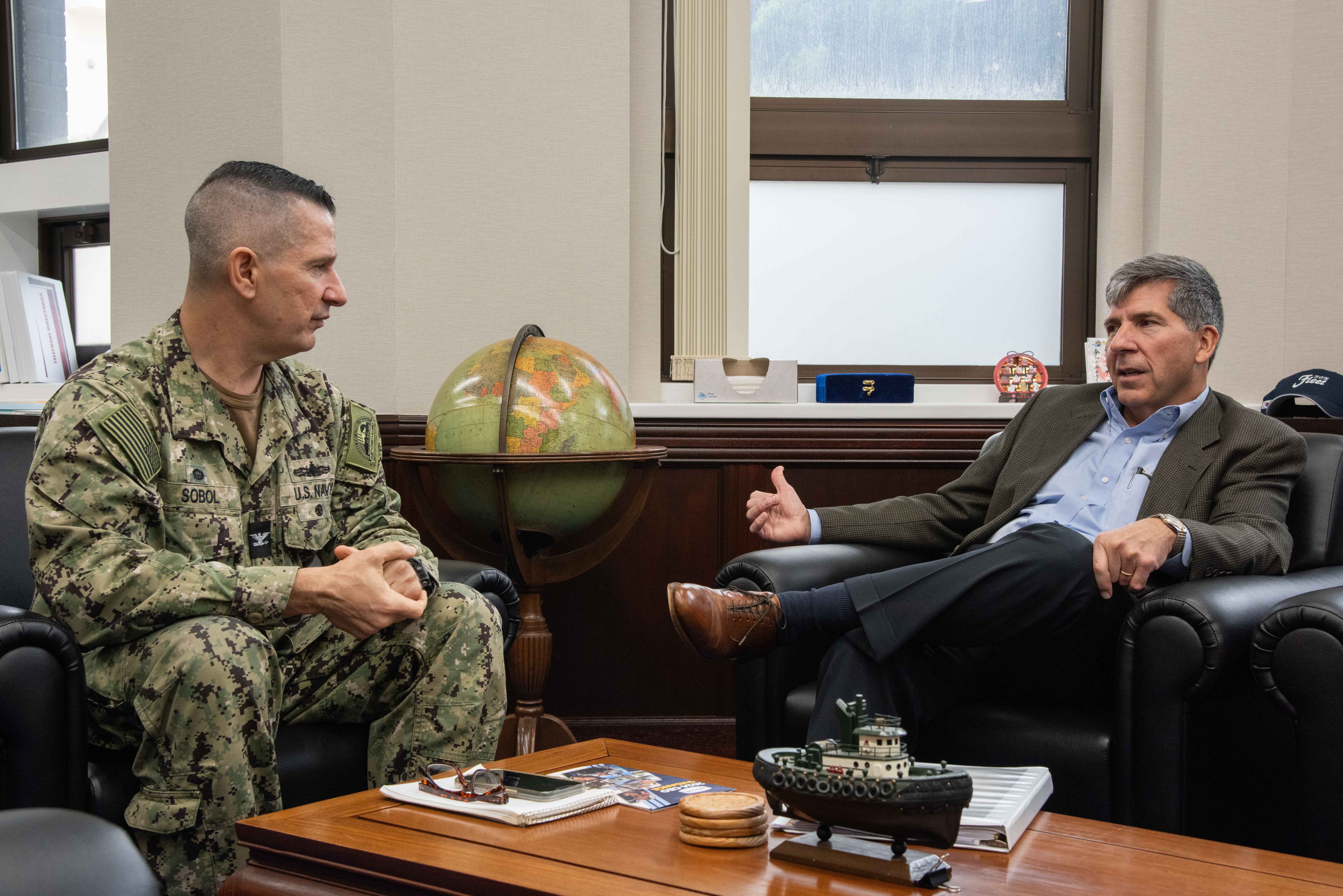 Chief Executive Officer, Navy Exchange Service Command, Robert J. Bianchi, a retired rear admiral with the Navy Supply Corps, speaks with Capt. Les Sobol, Commander, Fleet Activities Yokosuka (CFAY) during an office call.