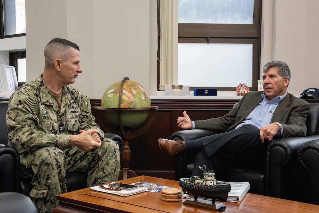 Chief Executive Officer, Navy Exchange Service Command, Robert J. Bianchi, a retired rear admiral with the Navy Supply Corps, speaks with Capt. Les Sobol, Commander, Fleet Activities Yokosuka (CFAY) during an office call.