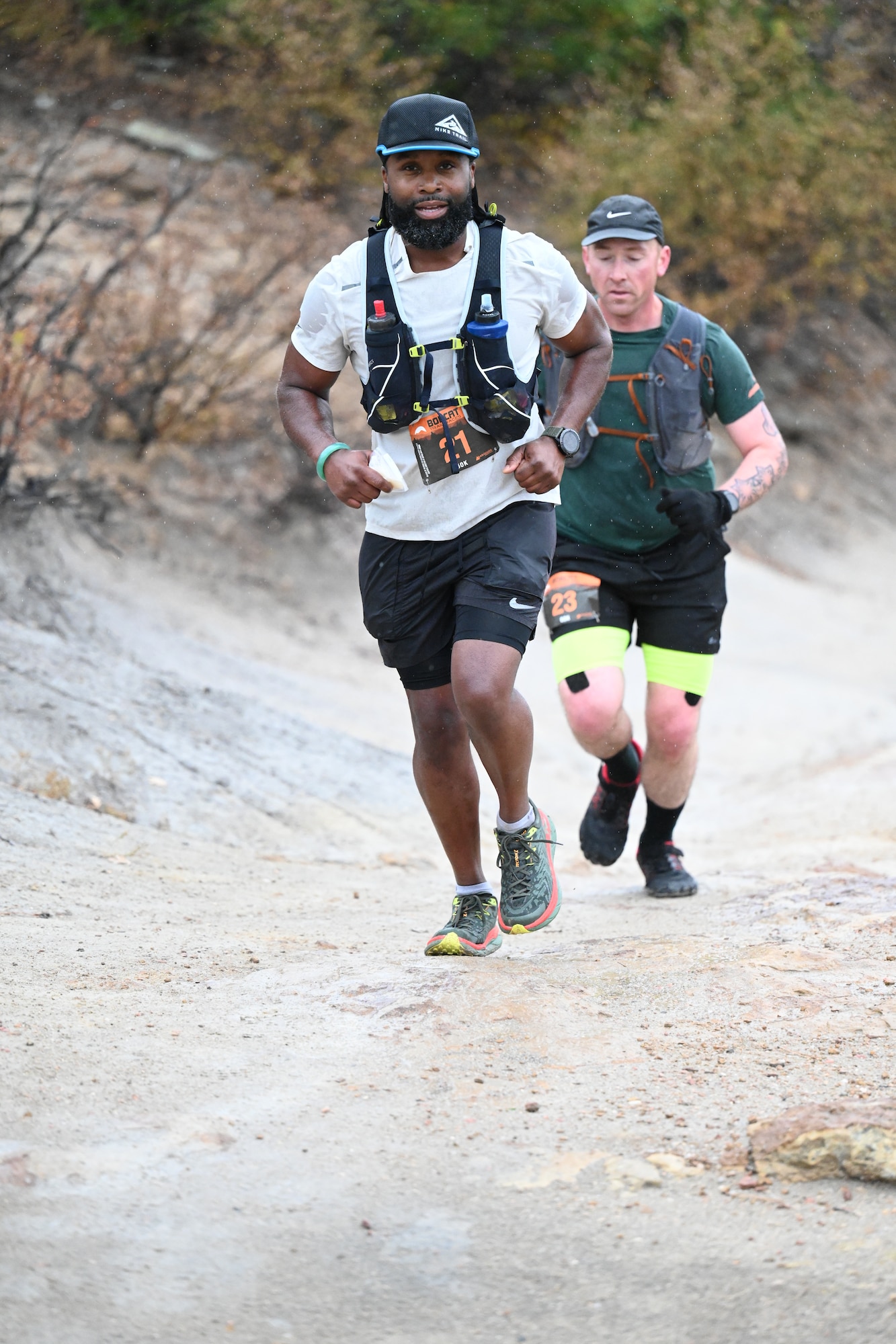 Two men running up hill