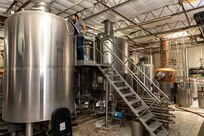 U.S. Air Force Master Sgt. Matthew Elder, Special Warfare Training Wing readiness flight chief, checks the mash process of a bourbon run at his job as a SkillBridge intern, San Antonio, Texas, May 10, 2024. The DOD SkillBridge Program allows separating service members to intern with approved industry partners for up to 180 days prior to their separation date as long as the obtain their chain of command approval. The program is designed to give service members valuable industry experience and help smooth the transition between military and civilian life. Elder used his SkillBridge benefit to explore career opportunities in the distilling and beverage industry. (U.S. Air Force photo by Ismael Ortega)