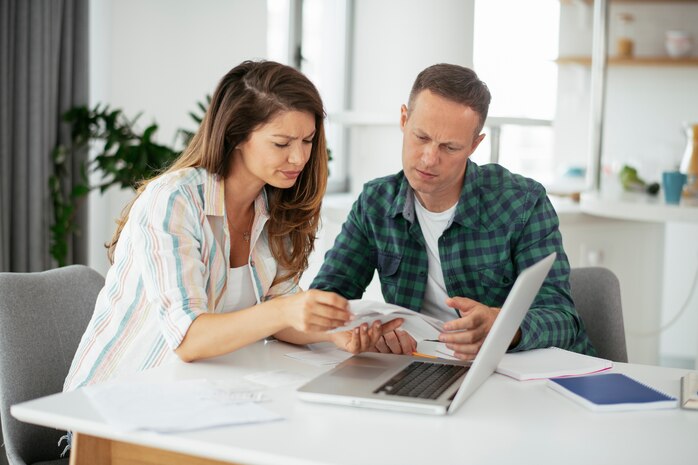 Husband and wife preparing bills to pay.