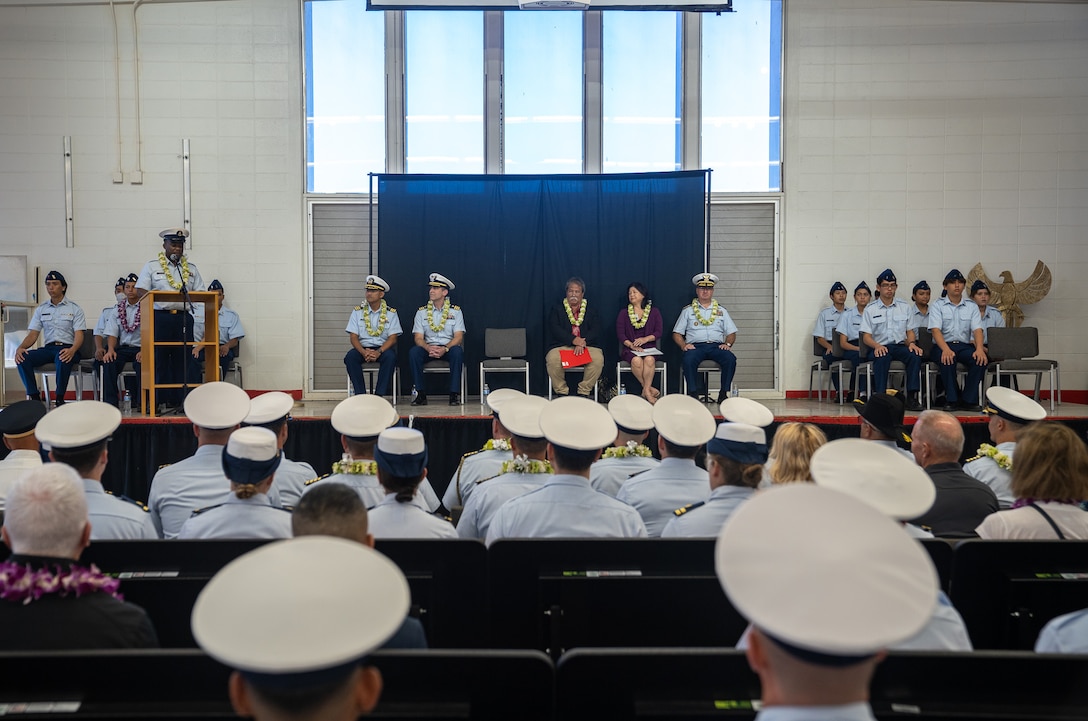 Retired Chief Petty Officer Ash Armstrong, Coast Guard JROTC instructor at Kalani High School, addresses a crowd of Coast Guard leaders, school administrators, cadets and families at a ceremony at the high school in Honolulu, Hawaii, Nov. 21, 2024. The Coast Guard established its first Hawaii-based JROTC unit with over 20 cadets enrolled. (U.S. Coast Guard photo by Petty Officer 2nd Class Tyler Robertson)