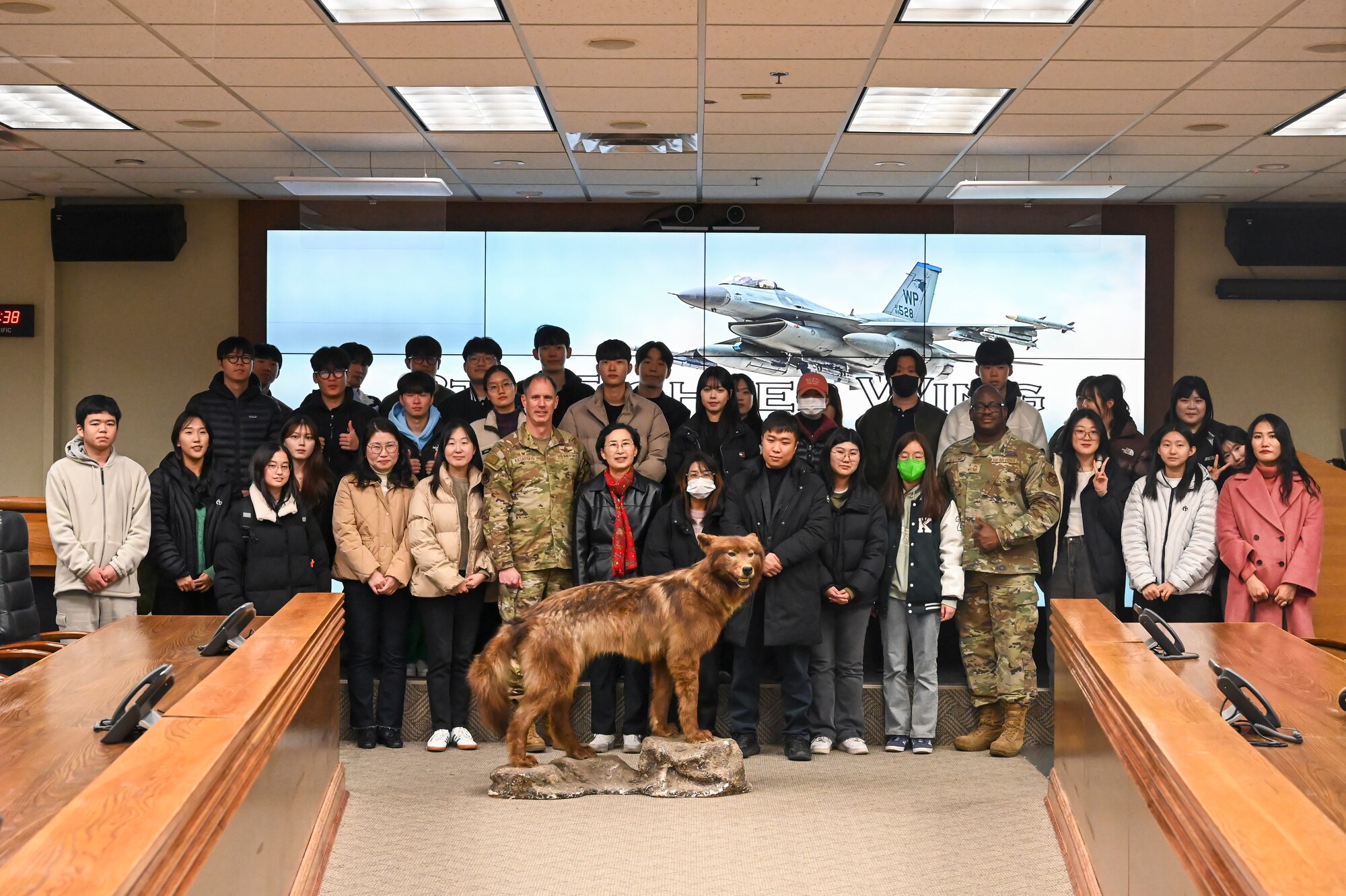 U.S. Air Force Col. Peter Kasarskis, 8th Fighter Wing Commander and Chief Master Sgt. Adegboyega Adeyemo, 8th Mission Support Group senior enlisted leader, pose for a photo with students from Kunsan National University during a base tour.