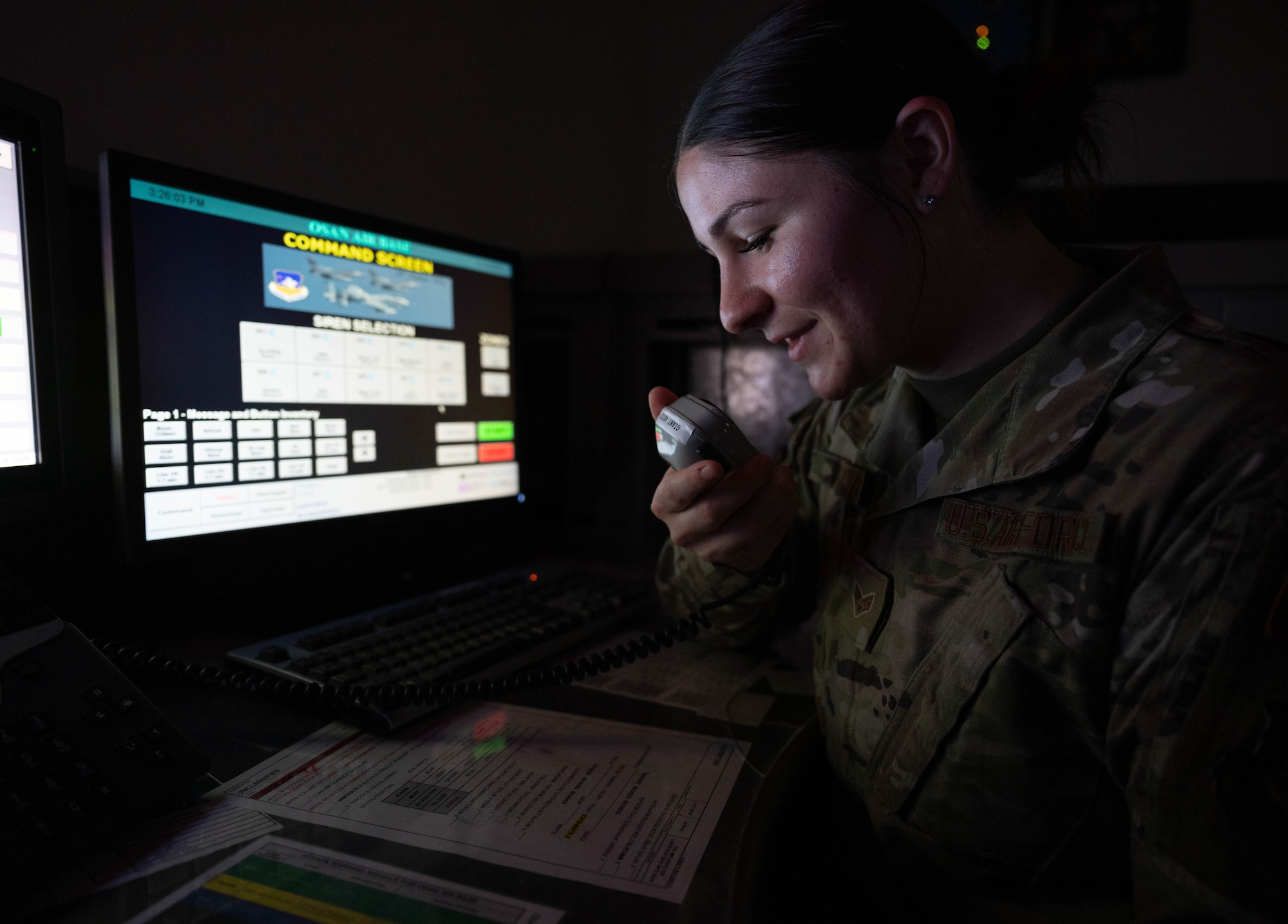 U.S. Air Force Senior Airman Lydia Heflin, 51st Fighter Wing Command Post emergency actions controller, speaks into a giant voice system at Osan Air Base, Republic of Korea, Nov. 19, 2024. As an emergency actions controller, Heflin monitors installation status and emergency situations throughout the base. (U.S. Air Force photo by Staff Sgt. Christopher Tam)
