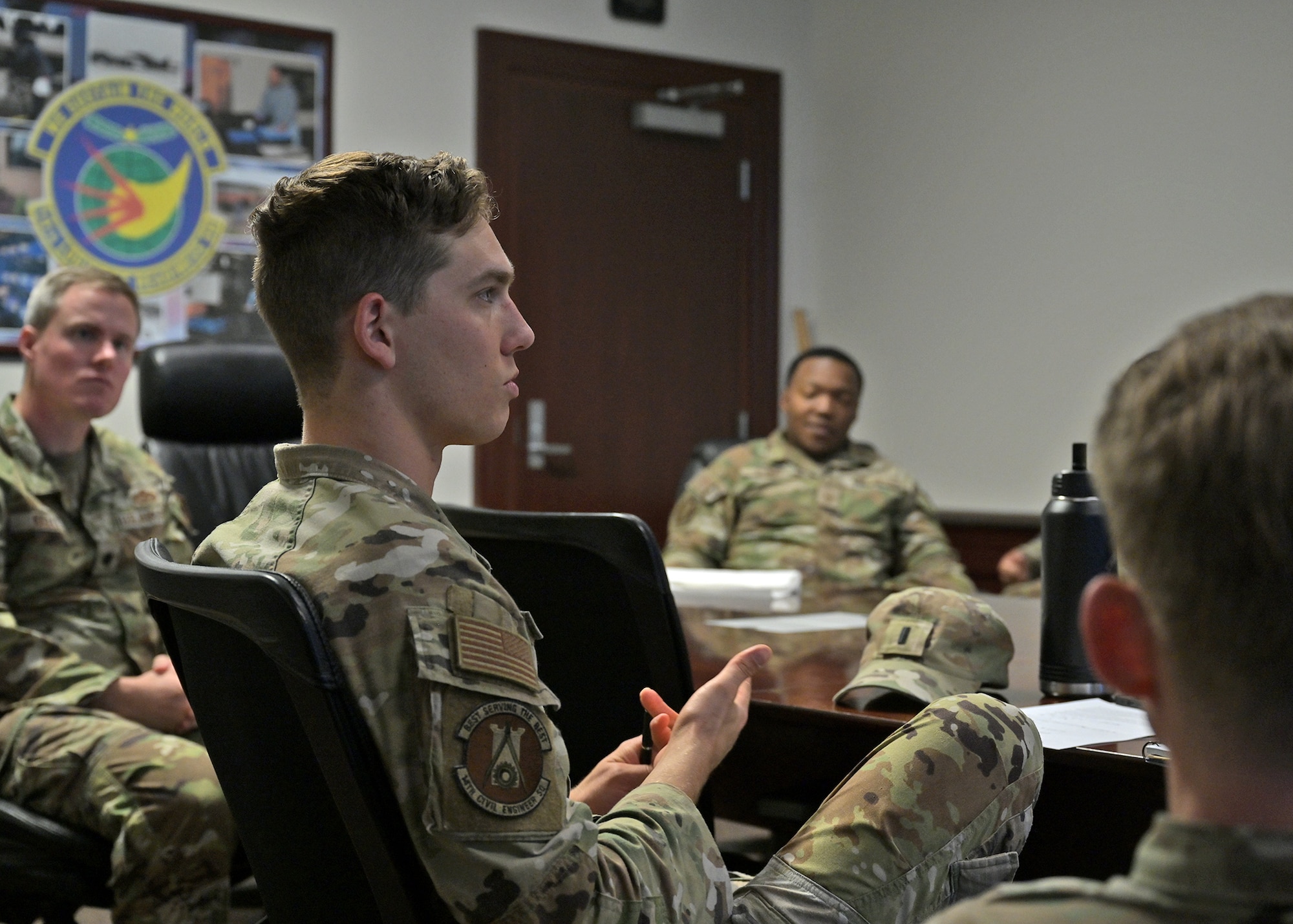 Members of the 14th Civil Engineer Squadron discuss the results of a virtual reality leadership training scenario.