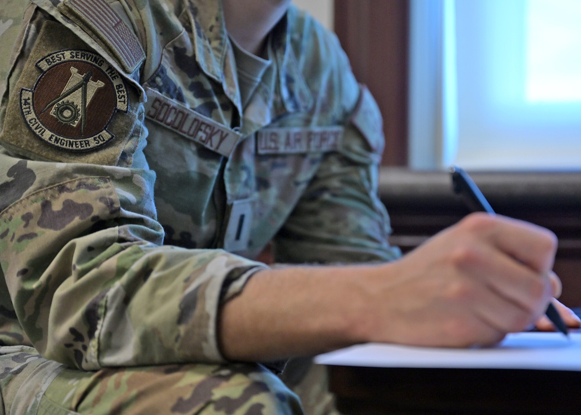 LT Socolofsky takes notes during a virtual reality leadership training event.