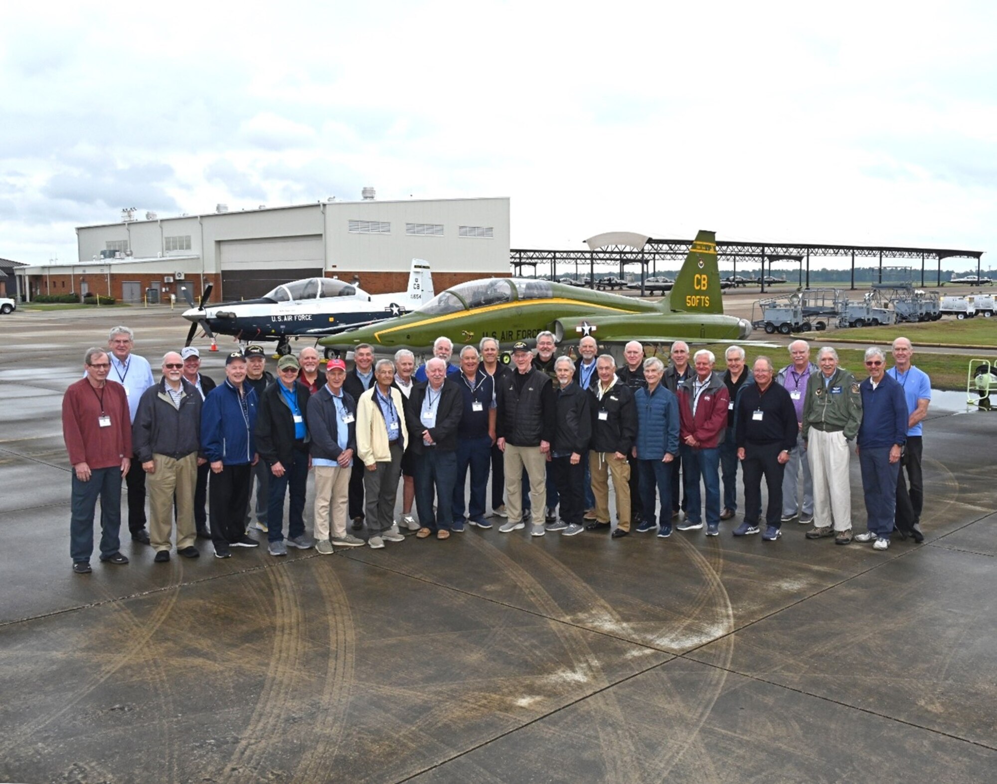 Former 50th Flying Training Squadron instructor pilots pose for a photo at Columbus Air Force Base, Mississippi, Nov. 13, 2024. The former instructor pilots returned for a reunion and learned about the changed of modern aviation.