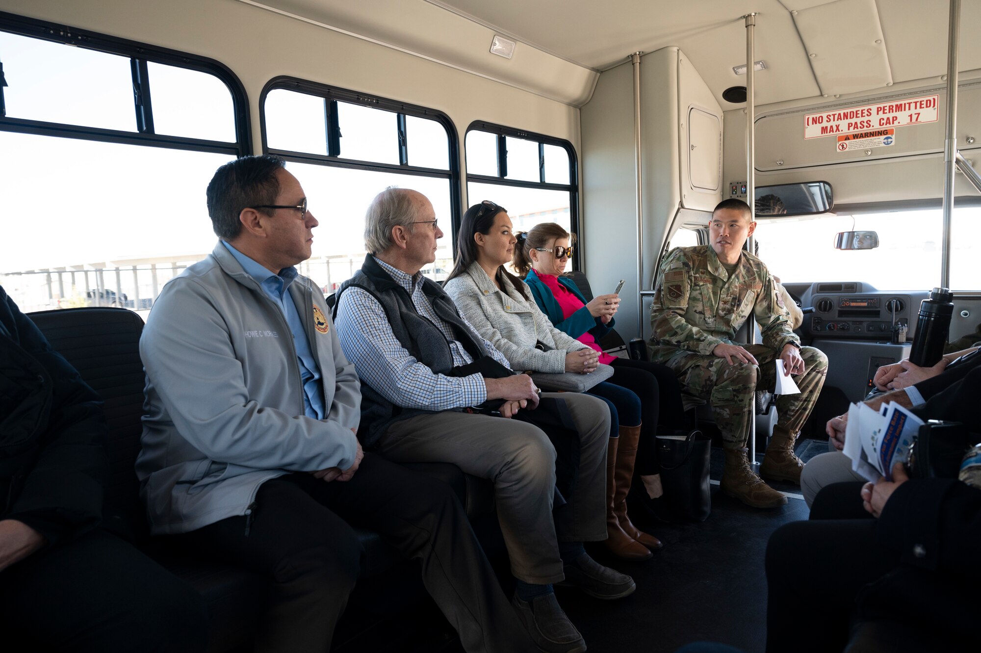 A group listens to a brief in a car.
