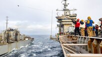 AOAN Cager Jack fires a shot line from USS Harry S. Truman (CVN 75) to USNS Arctic (T-AOE 8) during a replenishment-at-sea.