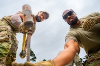 Air force troops working to build a tent