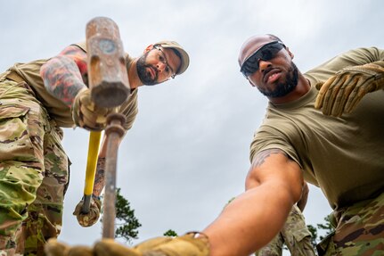 Air force troops working to build a tent