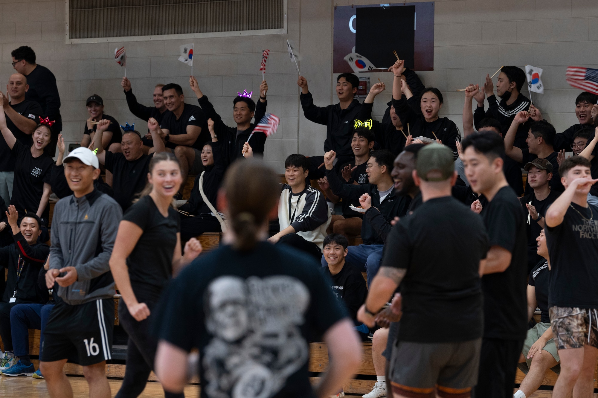 U.S. Air Force members assigned to Osan Air Base and members assigned to the Republic of Korea Air Force cheer on team members during a dodgeball game as part of the ROK-U.S. sports day at Osan AB, ROK, Nov. 15, 2024. Integration both inside and outside of their work environments is important to project strength and collaboration in monitoring any threats to the Korean peninsula ensuring Osan AB is ready to “Fight Tonight”. (U.S. Air Force photo by Staff Sgt. Ashley N. Mikaio)