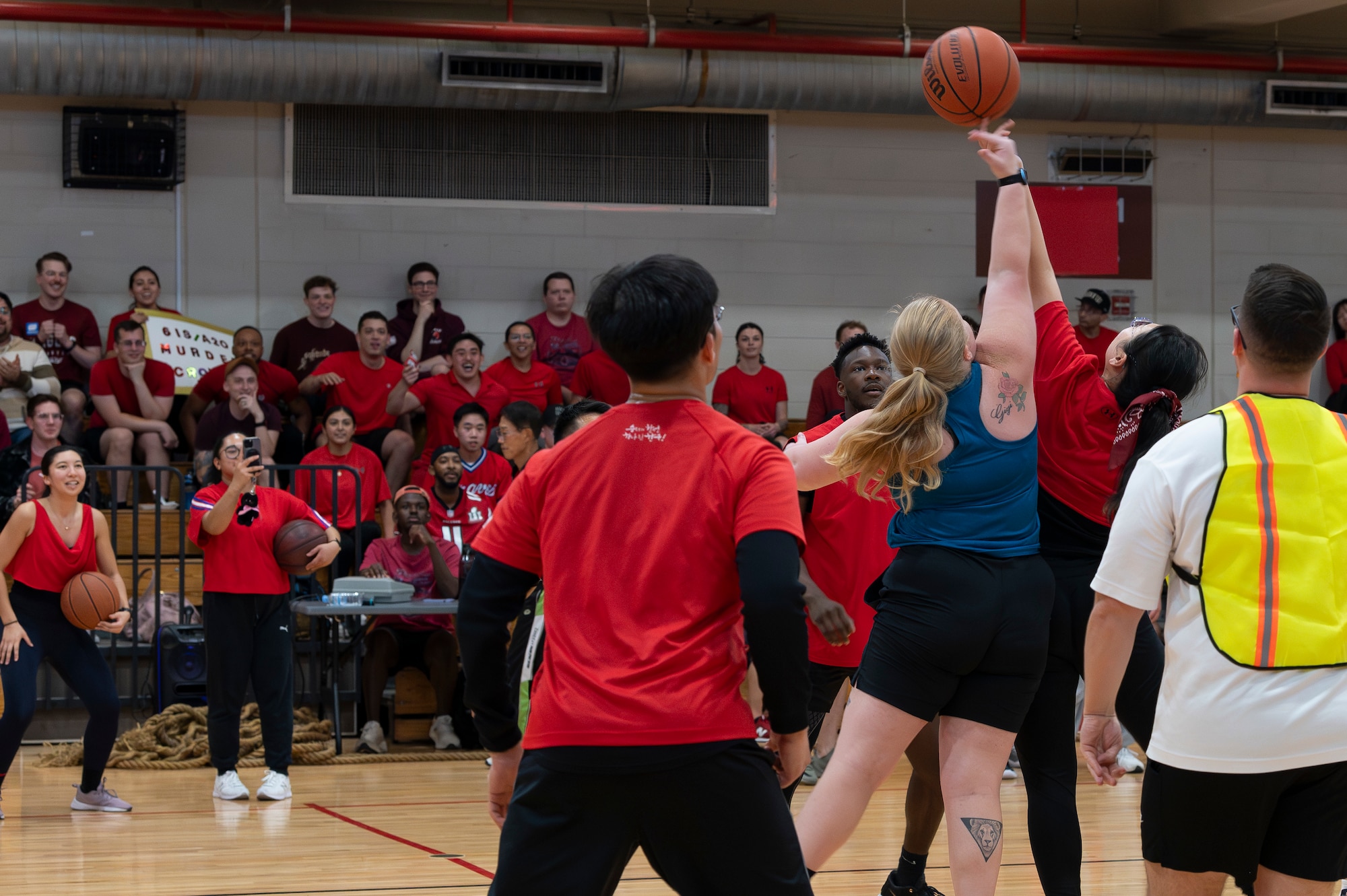 U.S. Air Force members assigned to Osan Air Base attempt to win the “tip off” of a basketball game during the Republic of Korea-U.S. sports day at Osan AB, ROK, Nov. 15, 2024. Members played on four different teams distinguished by attire to participate in a day of sportsmanship, camaraderie and fun. The cooperation of the U.S. and Republic of Korea Air Force intelligence forces are a crucial part of Osan AB staying ready to “Fight Tonight”. (U.S. Air Force photo by Staff Sgt. Ashley N. Mikaio)