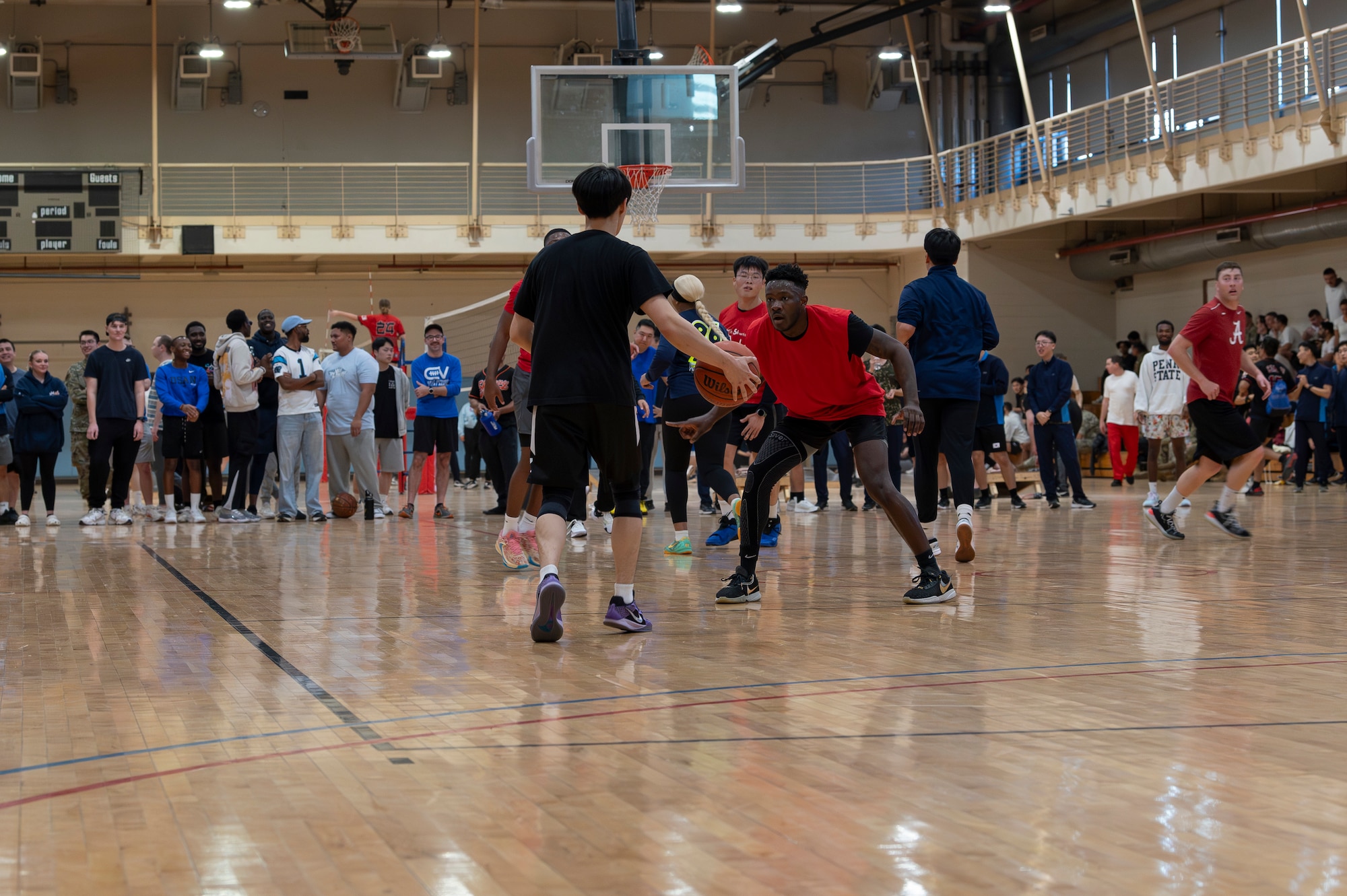 A U.S. Air Force member assigned to Osan Air Base defends against a Republic of Korea Air Force member during a basketball game as part of a sports day at Osan AB, ROK, Nov. 15, 2024. The ROK-U.S. sports day consisted of four teams participating in five sporting events to not only crown a winner, but come together in camaraderie and friendship as allies and partners. (U.S. Air Force photo by Staff Sgt. Ashley N. Mikaio)