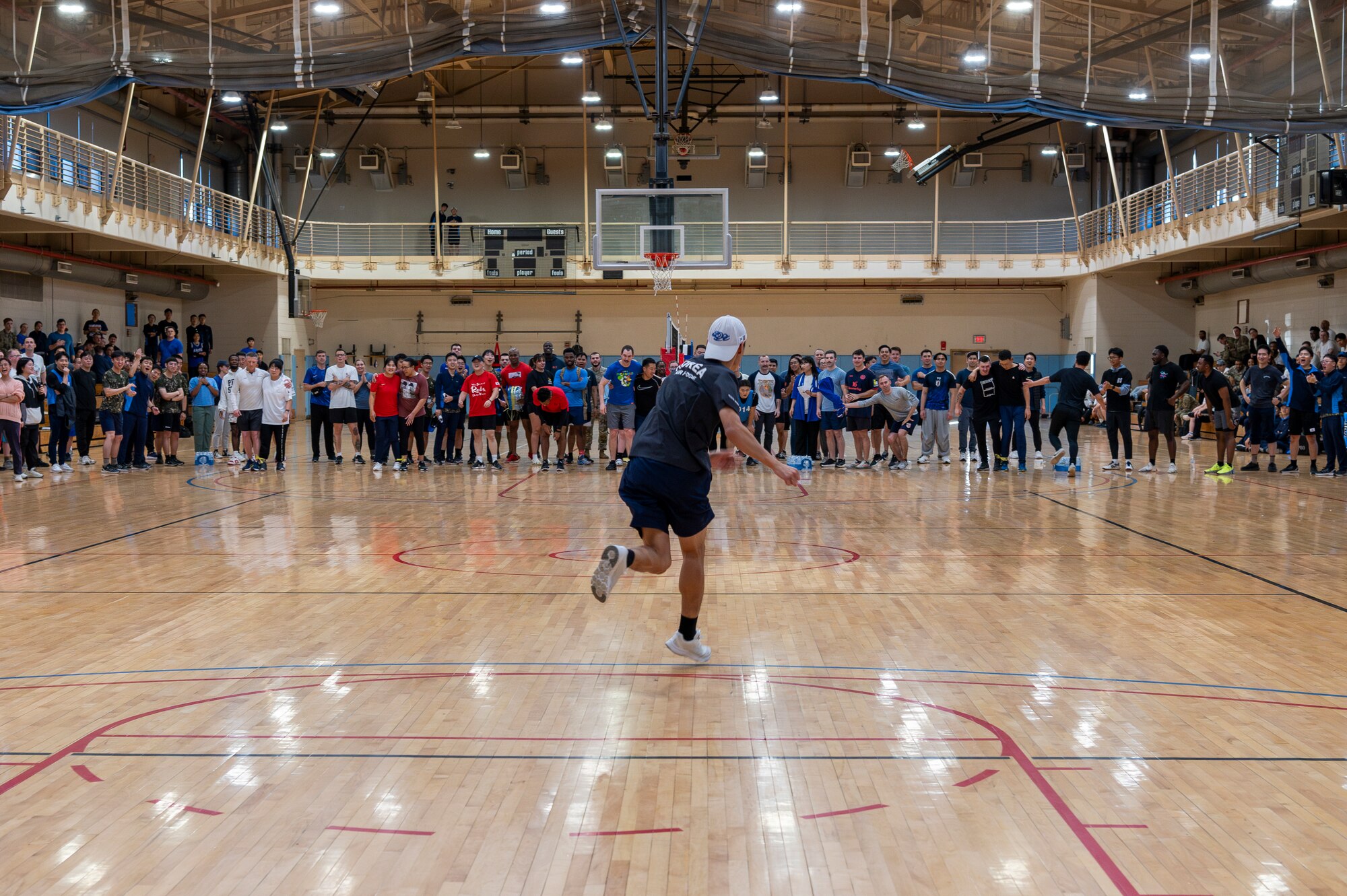 A Republic of Korea Air Force member  skips to his team during a relay race as part of an intel sports day at Osan Air Base, ROK, Nov. 15, 2024. Integration both inside and outside of their work environments is important to project strength and work together in monitoring any threats to the peninsula ensuring Osan AB is ready to Fight Tonight. (U.S. Air Force photo by Staff Sgt. Ashley N. Mikaio)