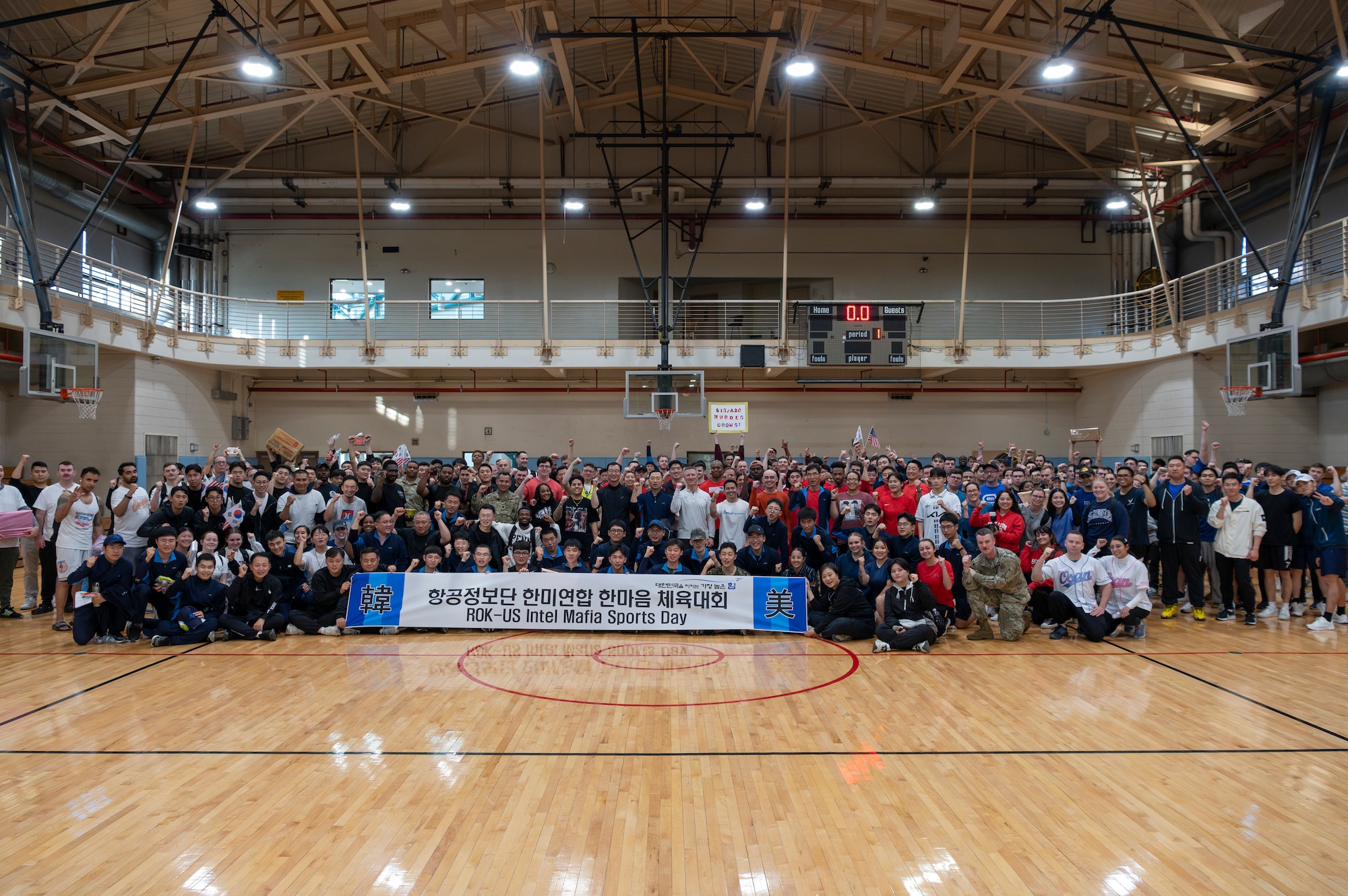 U.S. Air Force and Republic of Korea Air Force members pose for a group photo after a semi-annual intel sports day at Osan Air Base, ROK, Nov. 15, 2024. The members unified to make four teams to participate in five sporting events throughout the afternoon including volleyball, dodgeball, basketball, tug-of-war and a relay race. (U.S. Air Force photo by Staff Sgt. Ashley N. Mikaio)
