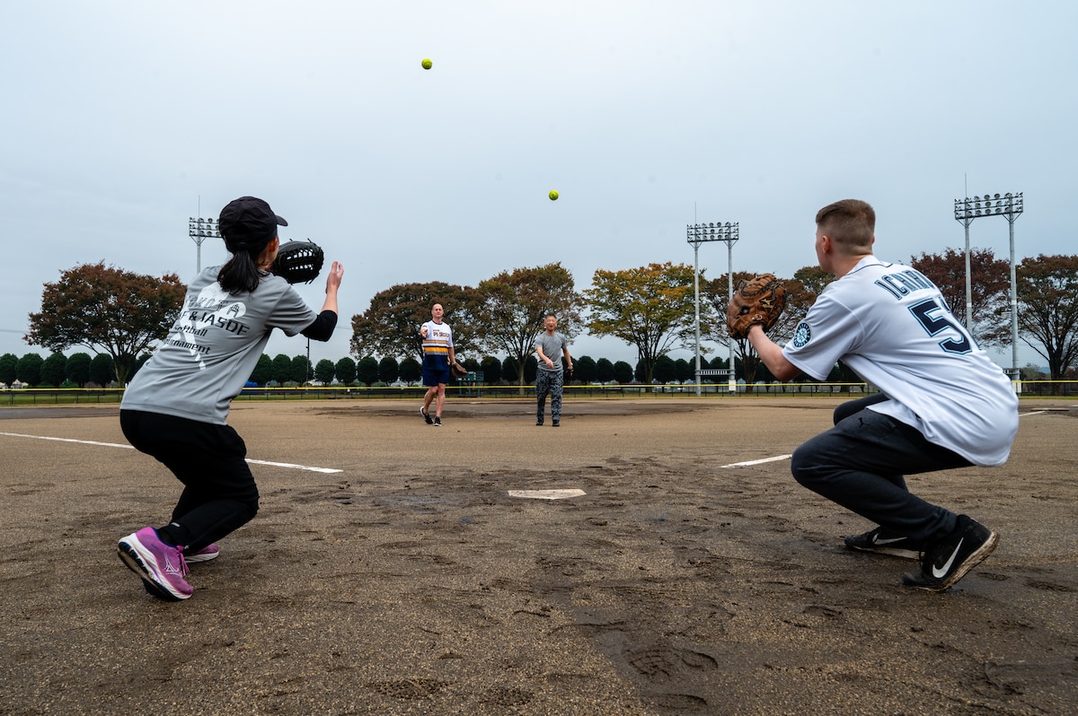 two people throwing a baseball