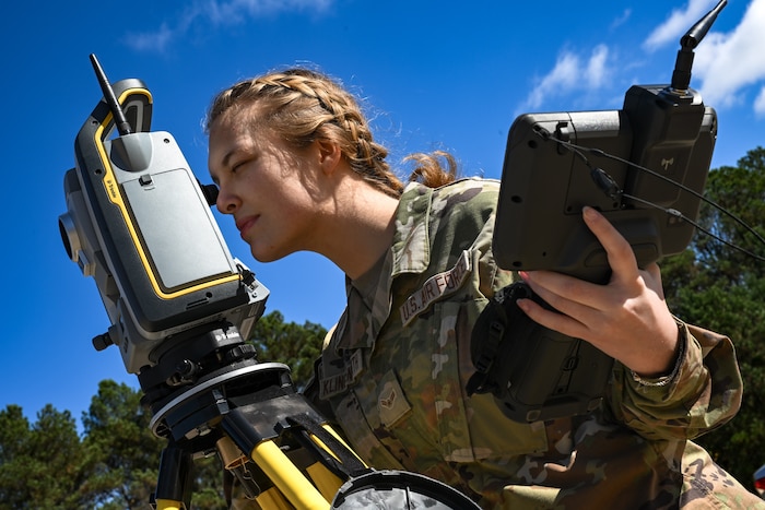 A Citizen Airman assigned to the 910th Civil Engineer Squadron looks through surveying equipment to evaluate the elevation of the practice flightline at Dobbins Air Reserve Base, Georgia, Nov. 15, 2024.