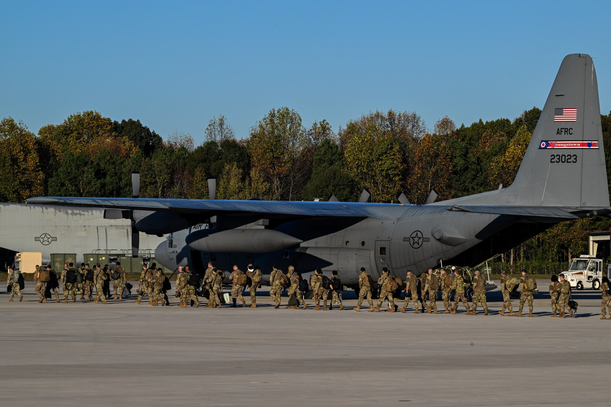 Citizen Airmen assigned to the 910th Airlift Wing walk toward a C-130H Hercules to travel back to Ohio on the flightline at Dobbins Air Reserve Base, Georgia, Nov. 16, 2024.