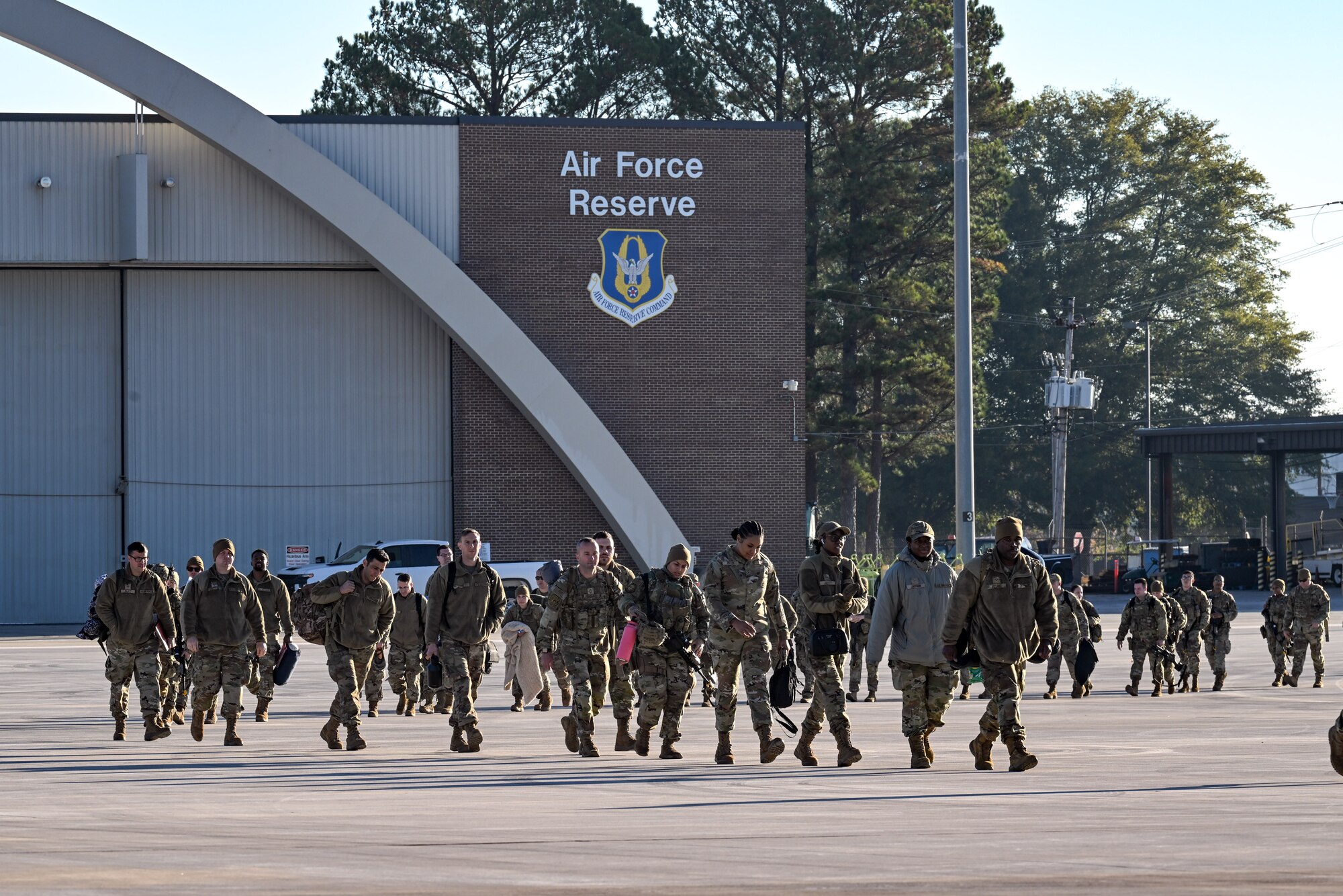 Citizen Airmen assigned to the 910th Airlift Wing walk toward a C-130J-30 Super Hercules to travel back to Ohio on the flightline at Dobbins Air Reserve Base, Georgia, Nov. 16, 2024.