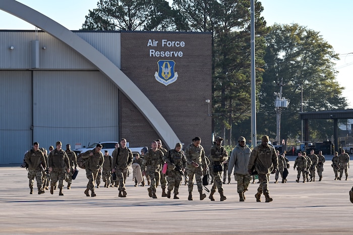 Citizen Airmen assigned to the 910th Airlift Wing walk toward a C-130J-30 Super Hercules to travel back to Ohio on the flightline at Dobbins Air Reserve Base, Georgia, Nov. 16, 2024.