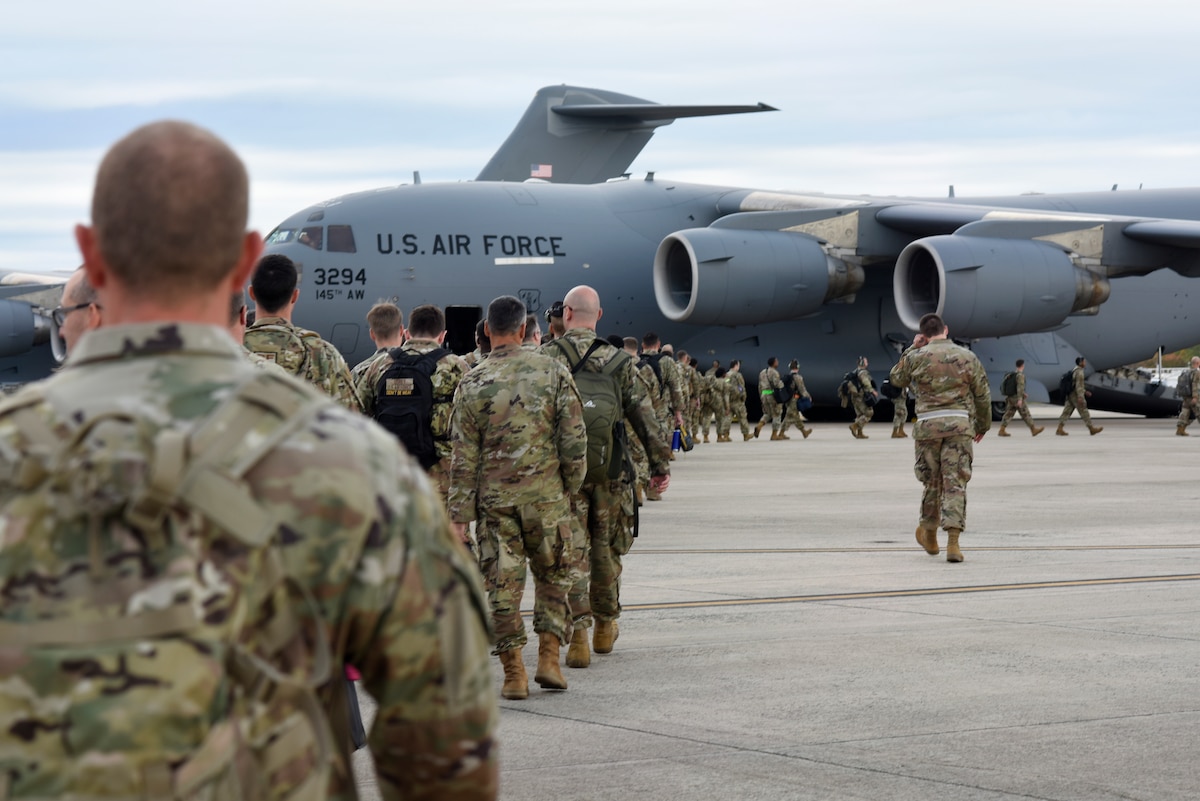 North Carolina Air National Guard members prepare to board a C-17 Globemaster III aircraft during a combat readiness inspection at the North Carolina Air National Guard Base, Charlotte-Douglas International Airport, Nov. 2, 2024.