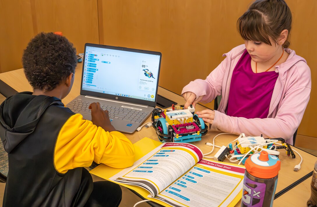 Two students collaborate on programming their robot during the Middle School Innovation Challenge @ Dahlgren, fine-tuning their design to tackle the competition’s missions. (Morgan Tabor/NSWCDD)