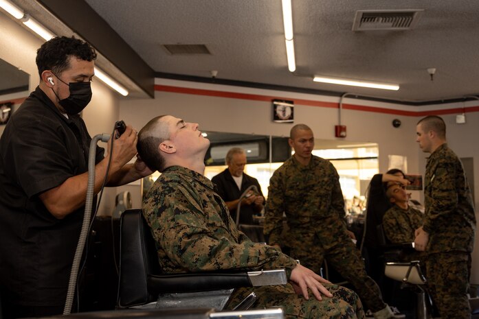 U.S. Marine Corps Recruit Chris Kendall with Echo Company, 2nd Recruit Training Battalion, receives his weekly haircut during a post exchange and haircut call at Marine Corps Recruit Depot San Diego, California, Nov. 18, 2024. Recruits are allowed to go to the PX to buy necessary supplies and receive haircuts weekly during their time at MCRD San Diego in order to maintain a uniform appearance and promote good hygiene throughout recruit training. (U.S. Marine Corps photo by Lance Cpl. Janell B. Alvarez)