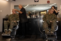 U.S. Marine Corps Recruit Matthew Devoy, left, and Rct. Jesus Alcaraz with Echo Company, 2nd Recruit Training Battalion, receive their weekly haircuts during a post exchange and haircut call at Marine Corps Recruit Depot San Diego, California, Nov. 18, 2024. Recruits are allowed to go to the PX to buy necessary supplies and receive haircuts weekly during their time at MCRD San Diego in order to maintain a uniform appearance and promote good hygiene throughout recruit training. (U.S. Marine Corps photo by Lance Cpl. Janell B. Alvarez)