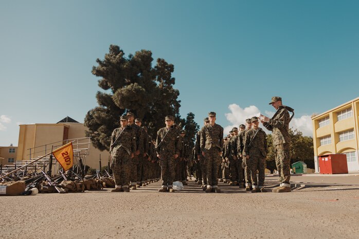 U.S. Marine Corps Recruit William Bennett with Echo Company, 2nd Recruit Training Battalion, reviews knowledge with the recruits during a post exchange and haircut call at Marine Corps Recruit Depot San Diego, California, Nov. 18, 2024. Recruits are allowed to go to the PX to buy necessary supplies and receive haircuts weekly during their time at MCRD San Diego in order to maintain a uniform appearance and promote good hygiene throughout recruit training. (U.S. Marine Corps photo by Lance Cpl. Janell B. Alvarez)
