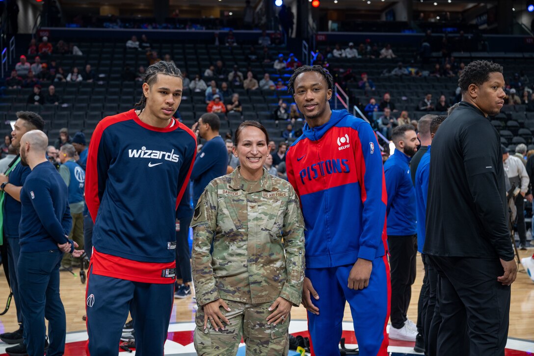 Two men and a woman pose for a photo